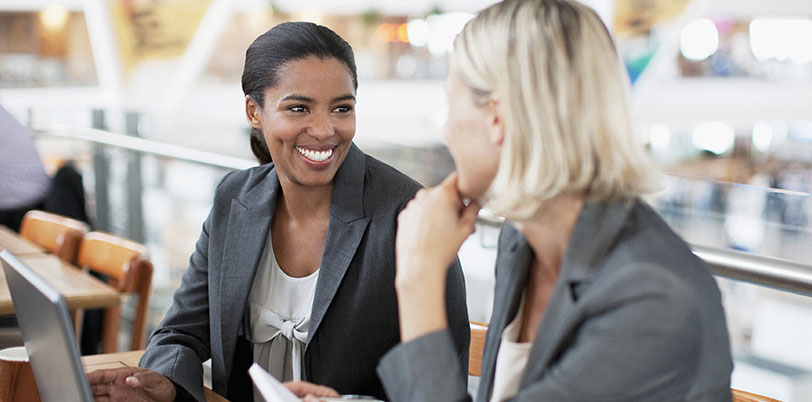 Two women talking at workplace