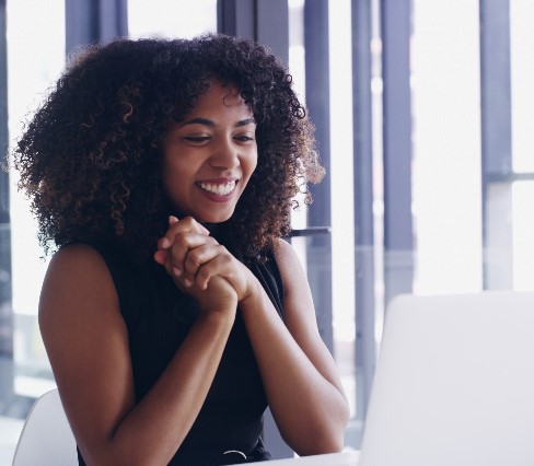 Smiling women with curly hair on screen